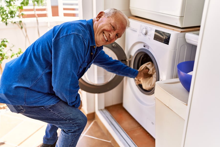 Senior Caucasian Man Smiling Happy Doing Laundry At The Terrace