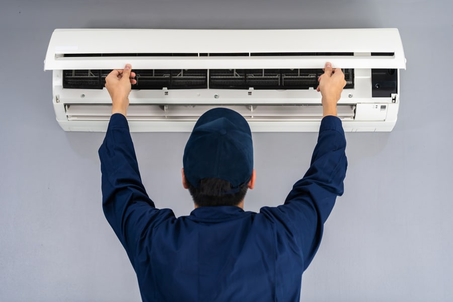 Technician Service Checking And Repairing Air Conditioner Indoors