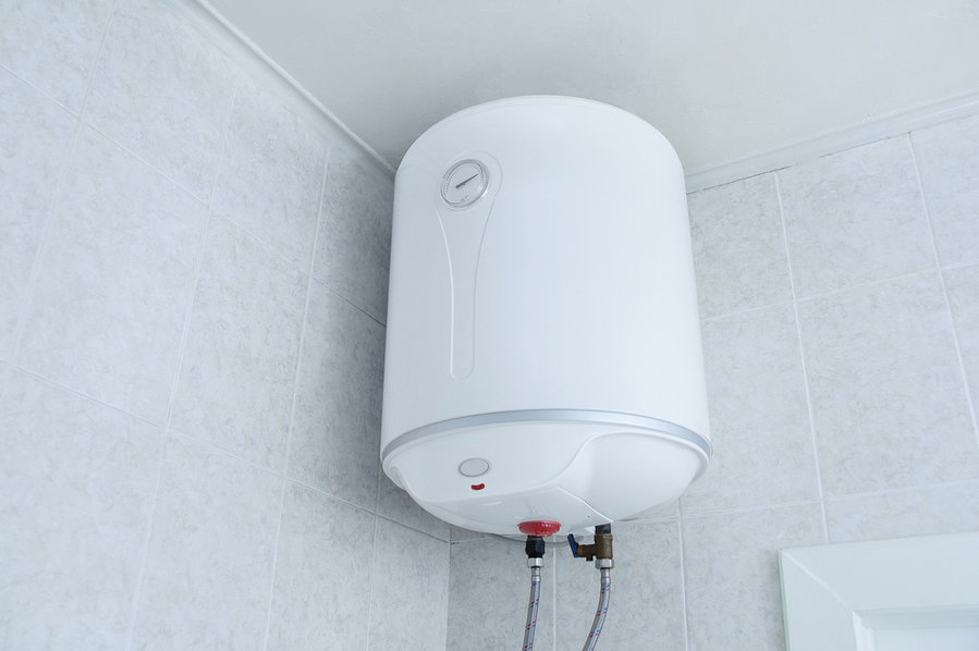 White Electric Water Heater Boiler On The Wall In The Bathroom.