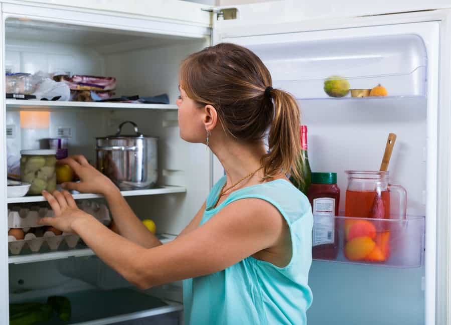 Woman Standing Near Refrigerator