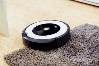 Wyze Vacuum Cleaner Roomba Cleaning A Gray Carpet.