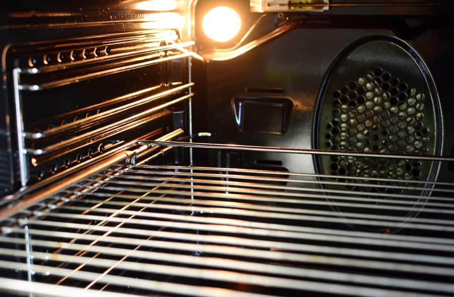 A View Of The Inside Of An Empty Oven With Lighting Bulb And A Wire Rack