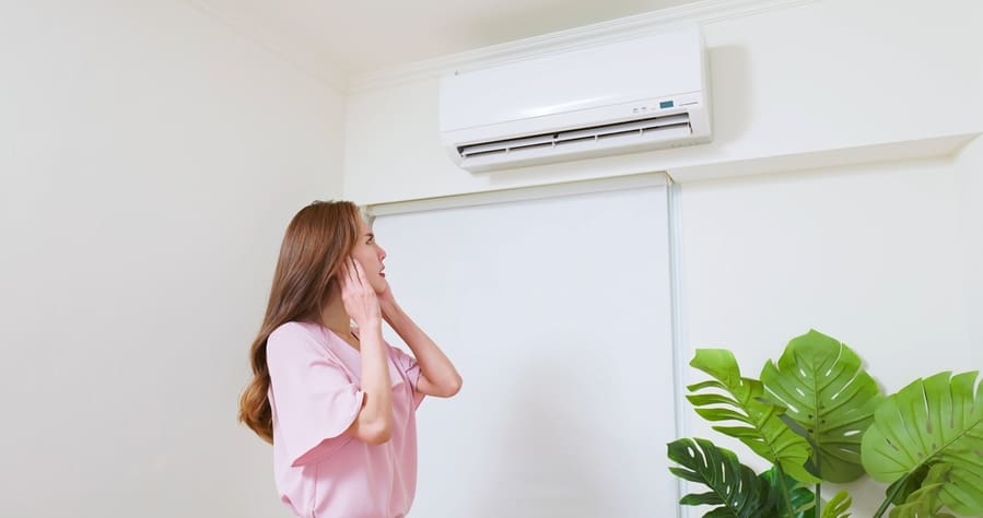 Asian Woman Trying Covering Her Ears Is Annoyed And She Is Suffering Noise From Air Conditioner At Home