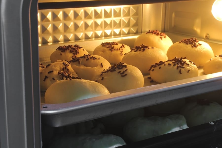 Brioche Bun With Chocolate Toppings Being Baked In The Electric Oven