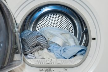 Close Up View On Clothes Dryer With Washed And Dried Shirts