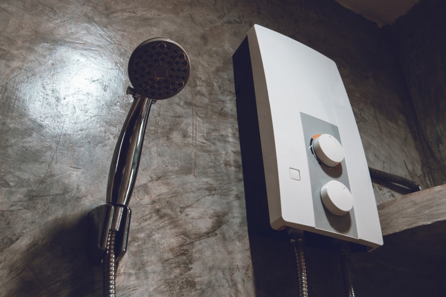 Electric Water Heater On The Cement Wall In Bathroom