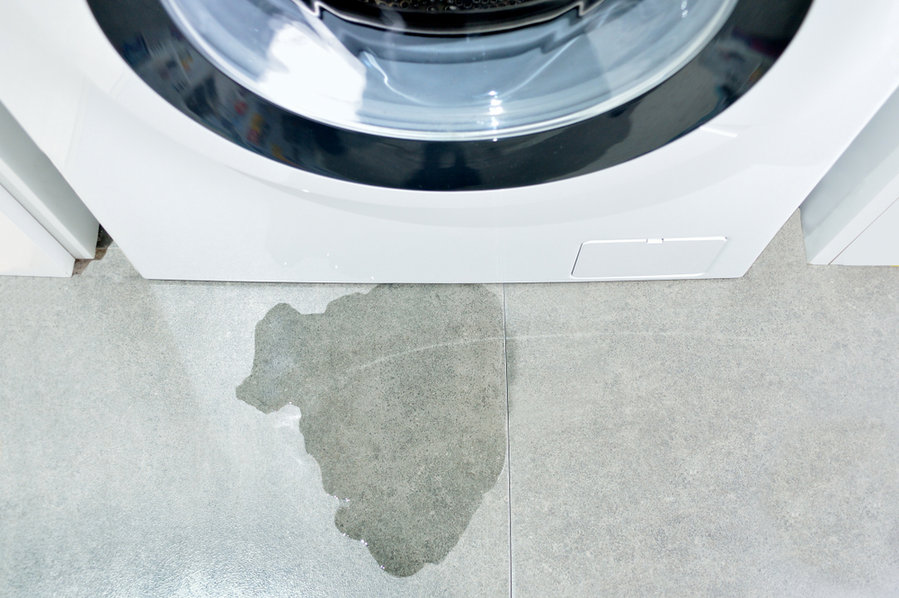High Angle Image Of A Washing Machine With Drain Pipe Leaking Water
