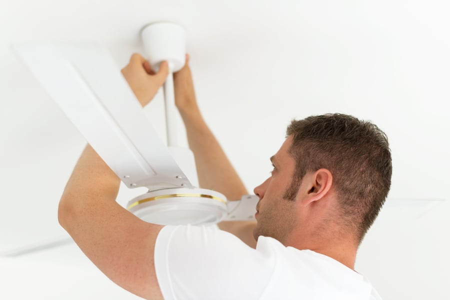 Male Technician Installing Ceiling Fan