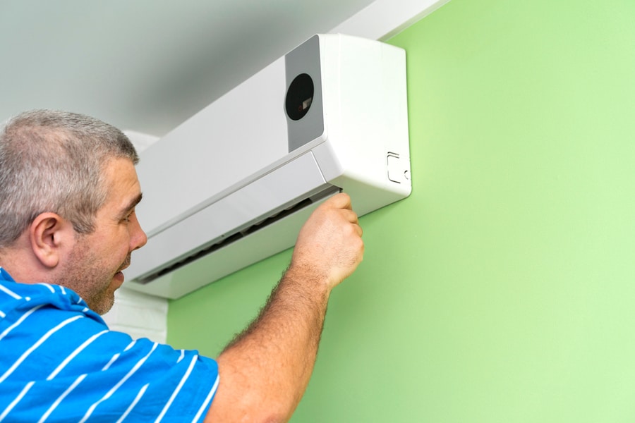 Male Technician Repairing And Diagnosing Air Conditioners