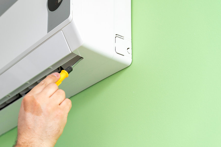 Male Technician Repairing And Diagnosing Air Conditioners