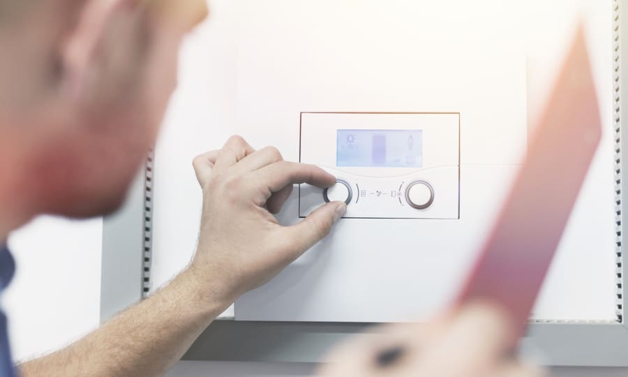 Man Setting The Temperature After Installing Water Heater
