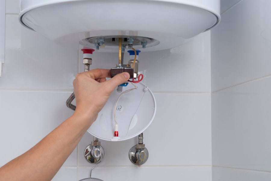 Master Holds A Thermostat From An Electric Boiler In His Hand