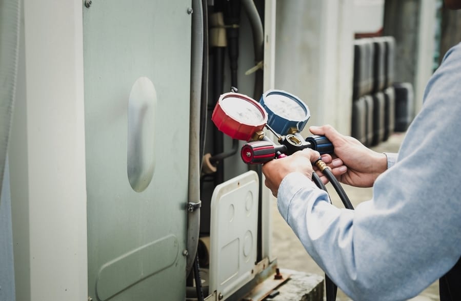 Mechanic Air Conditioner Technician Is Using A Manifold Gauge To Check The Refrigerant In The System