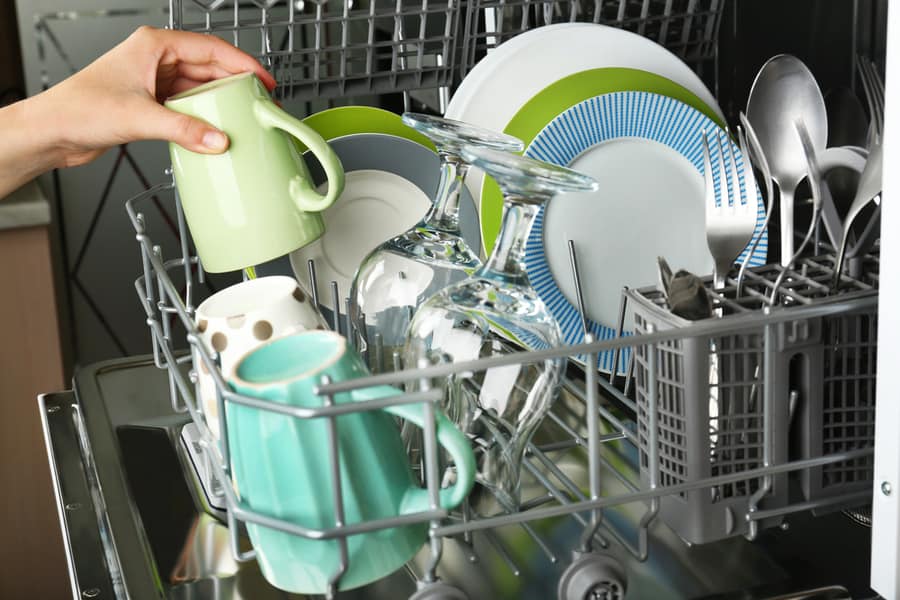 Open Dishwasher With Clean Utensils In It