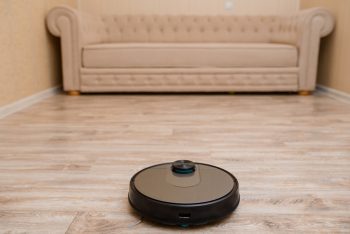 Robot Vacuum Cleaner Is Cleaning The Floor In The Living Room