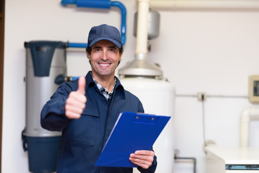 Smiling Technician Servicing A Hot-Water Heater