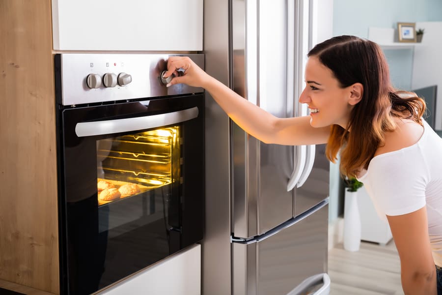 Woman Baking In Oven