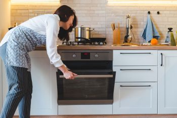 Woman Open Oven To Cook